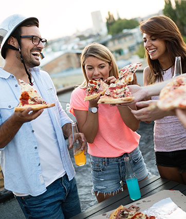 4 people eating pizza slices